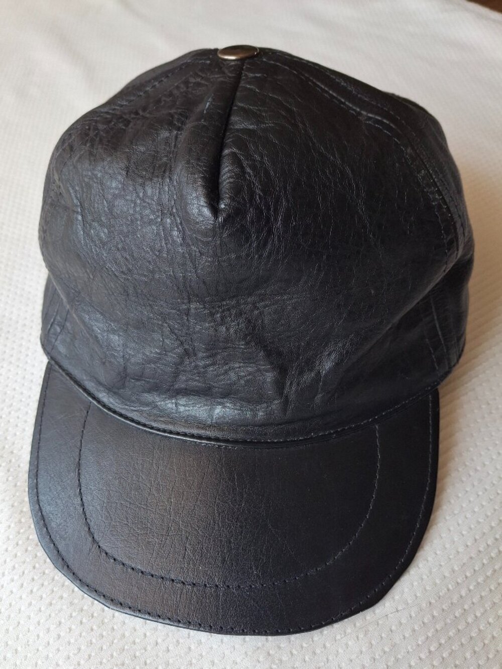 Black baseball cap made of soft leather with an adjustable strap